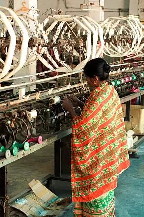 Worker at a weaving machine