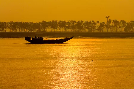 Small wooden boat at sunrise